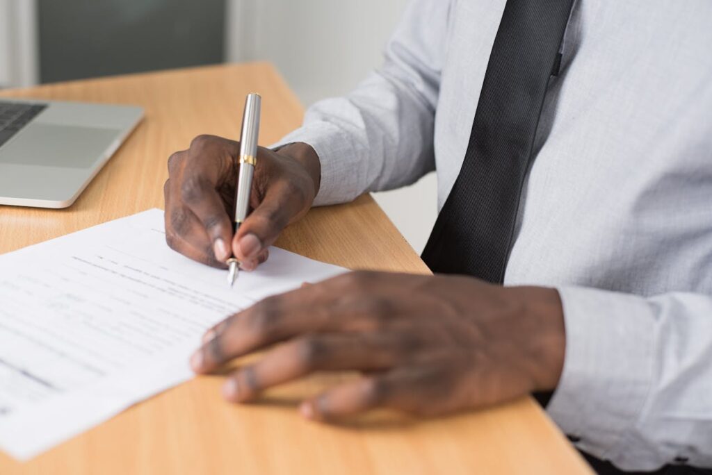 A man signing a Texas DSCR loan form. 