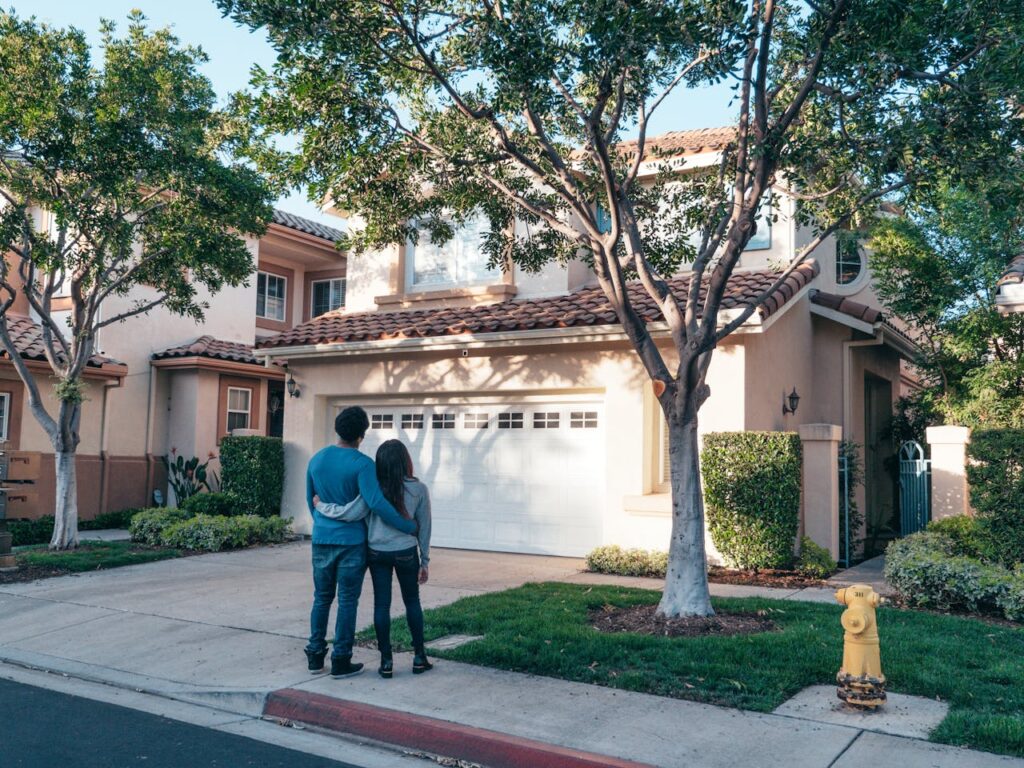 Fix-and-Flip Loans: The Complete Guide 2 A young couple standing in front of their new house that was purchased with a conventional loan rather than a fix-and-flip loan.