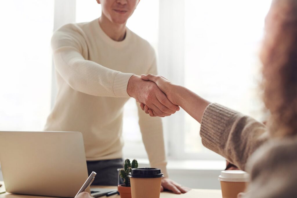 Buying an Investment Property in the US: The Complete Guide 2 A lender is shaking their client's hand after closing a deal on an investment property.