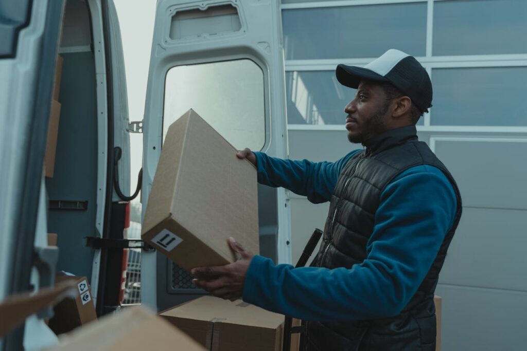 Colorado Bank Statement Loans: The Complete Guide 2 A gig worker, who is an ideal candidate for a Colorado bank statement loan, is taking packages out of a van.