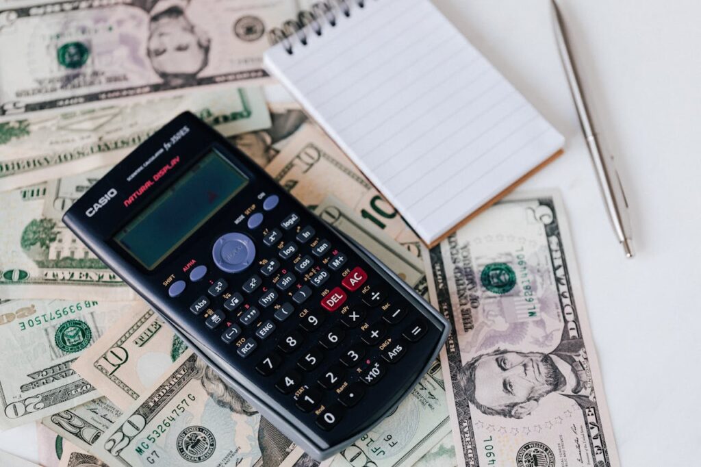 Tennessee DSCR Loans: The Complete Guide 3 US dollar notes with a calculator and notepad to determine the pros and cons of getting a Tennessee DSCR loan