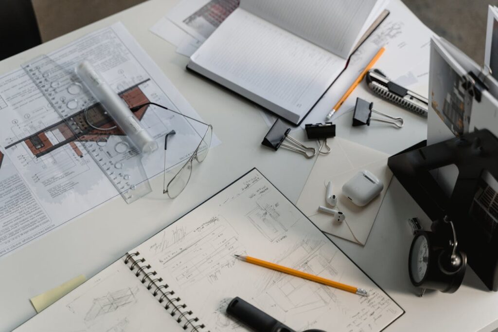 DSCR Loans for Fix-and-Flip Projects: Is It a Good Fit? 1 A table with building plans, pencils, rulers, and more with plans to renovate a property that was purchased with DSCR loans for fix-and-flip projects.