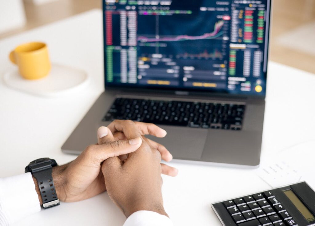 Mortgage Interest Rates: What Happens When They Drop? 3 A person has their hands folded while looking at interest rates on their laptop.