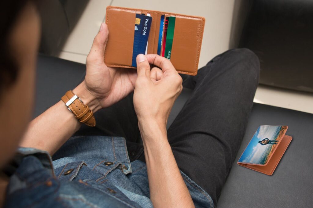 How to Improve Your Credit Score as a Self-Employed Individual for Better Mortgage Rates 3 A man is looking through his wallet to grab his credit card.