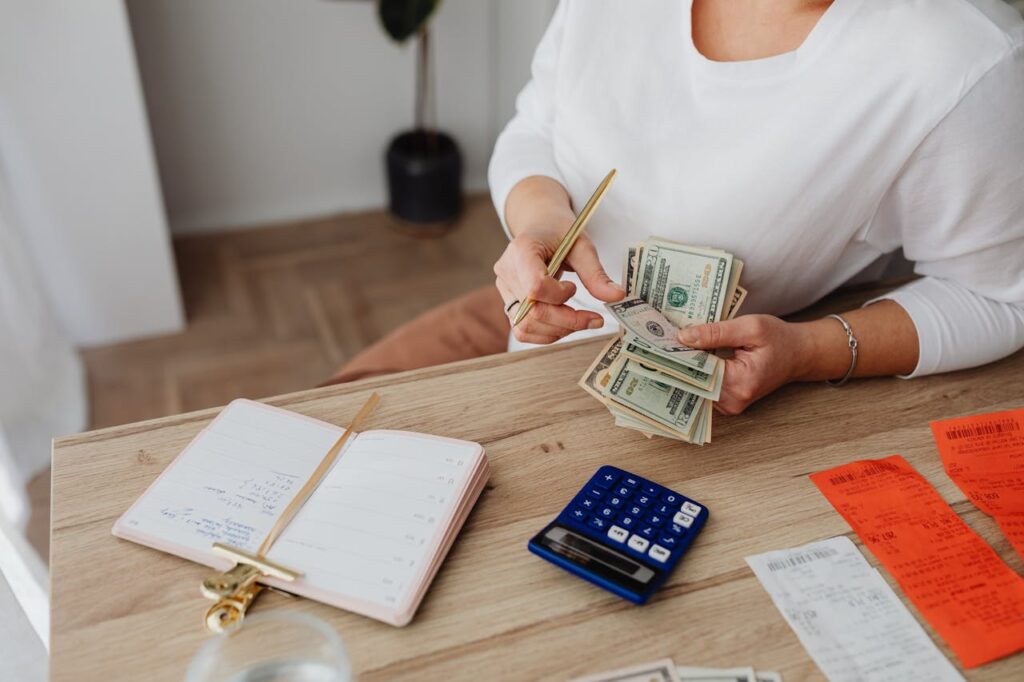Conventional Loan Florida: What Homebuyers Need to Know 2 A woman is counting out cash to see if she has enough for a conventional loan Florida down payment.