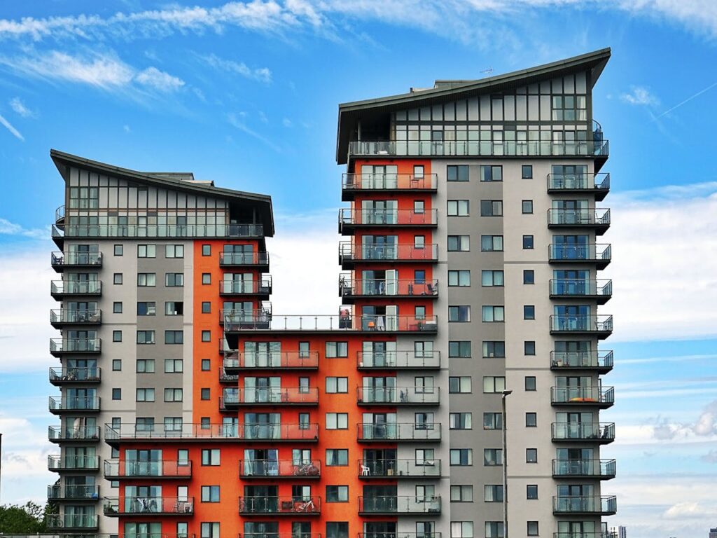 DSCR Loan Connecticut: Financing Your Growing Portfolio 2 The exterior of an apartment building with orange and grey paint that was financed with a DSCR loan Connecticut.