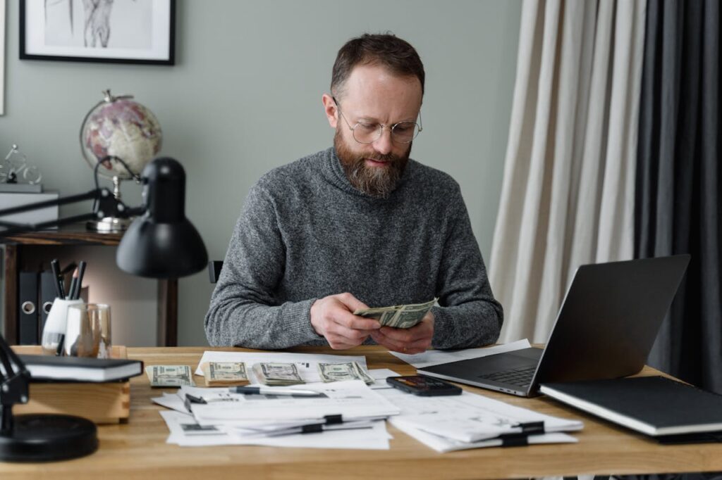 DSCR Loan Connecticut: Financing Your Growing Portfolio 3 A real estate investor is doing his calculations to make sure he can afford the down payment for his DSCR loan Connecticut.