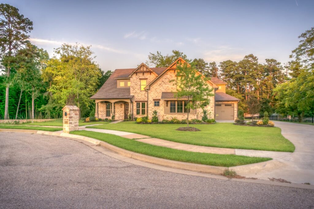 Jumbo Loan Georgia Guide: Maximize Your Home Buying Power 1 A brown brick colonial home that was purchased using jumbo loan Georgia options.