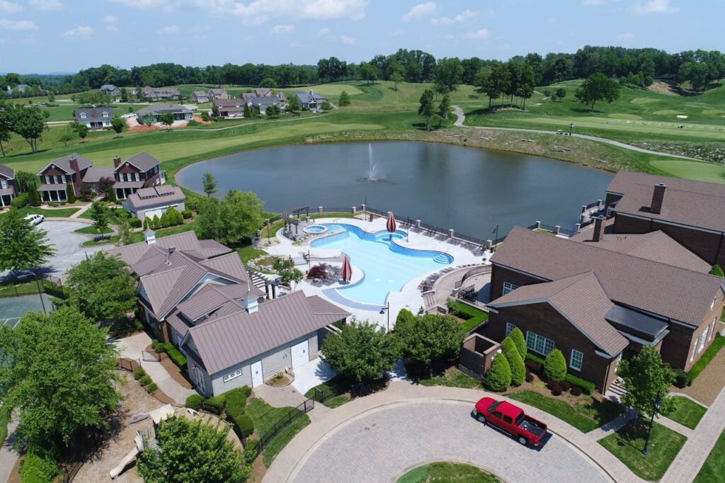 Large homes with a shared pool, next to a small pond and golf course in Bowling Green, Kentucky. 