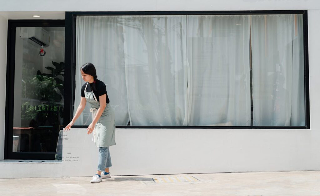 Unlocking Cash With a Bank Statement Home Equity Loan 2 A cafe owner, who would be eligible for a bank statement home equity loan, is putting out a sign in front of her cafe.