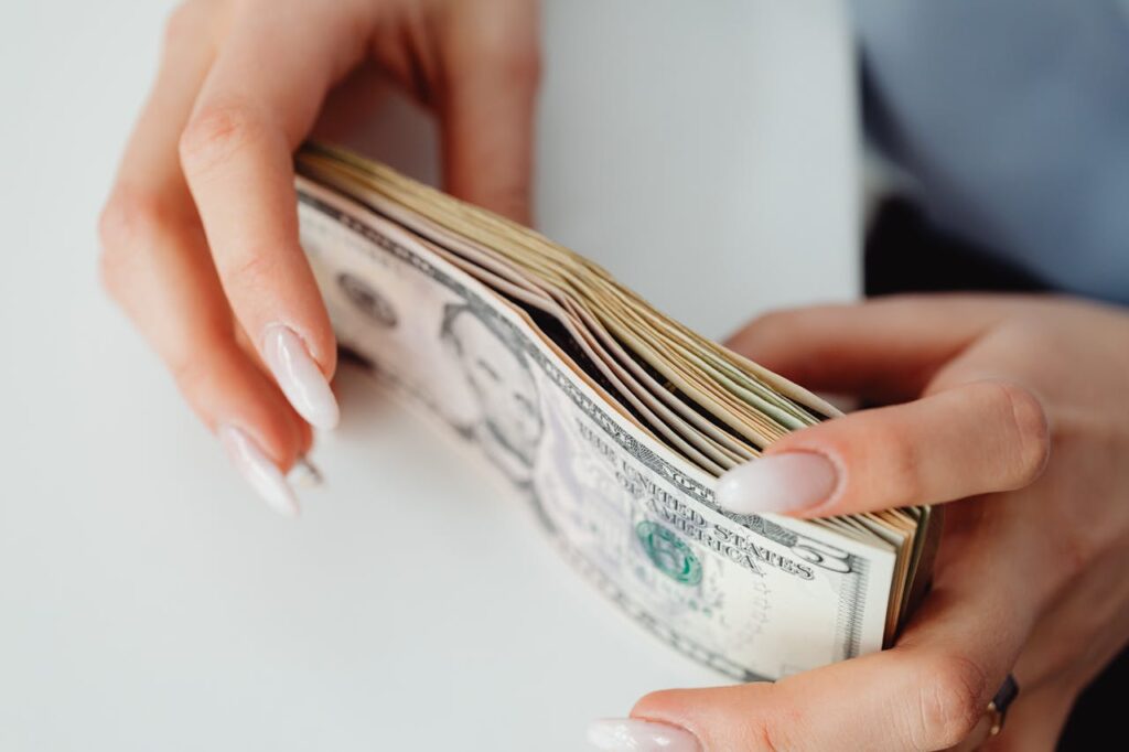 Unlocking Cash With a Bank Statement Home Equity Loan 3 A woman is stacking bank notes of the cash she received from a bank statement home equity loan.