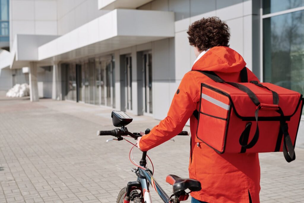 How to Get a Loan Without a Job: Practical Tips and Options 1 A delivery man in an orange jacket with his bike.