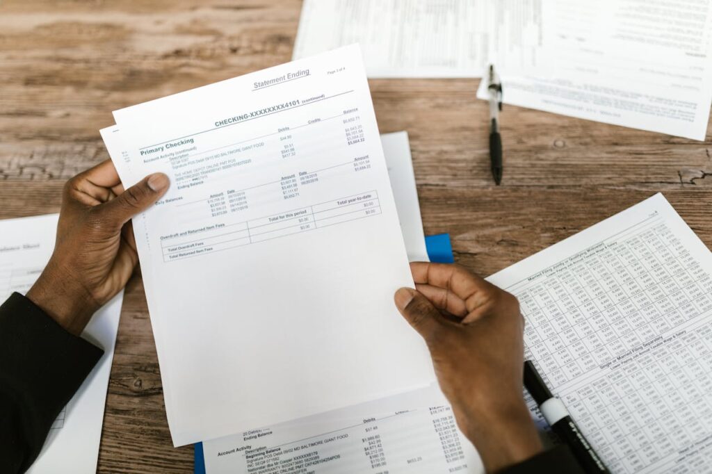 How to Get a Loan Without a Job: Practical Tips and Options 2 A man holding his bank statement, which is how to get a loan without a job if you still have steady bank deposits from other income sources.