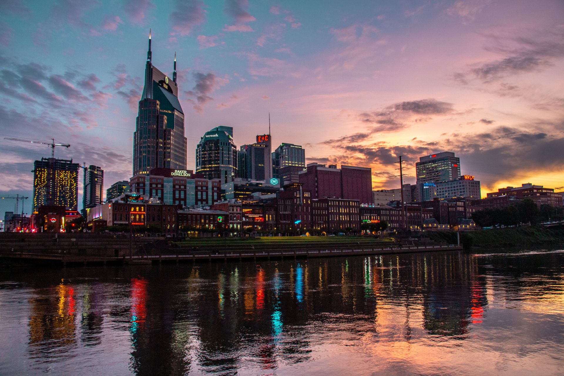 The Digital Deed 24 City skyline reflected in the water at dusk